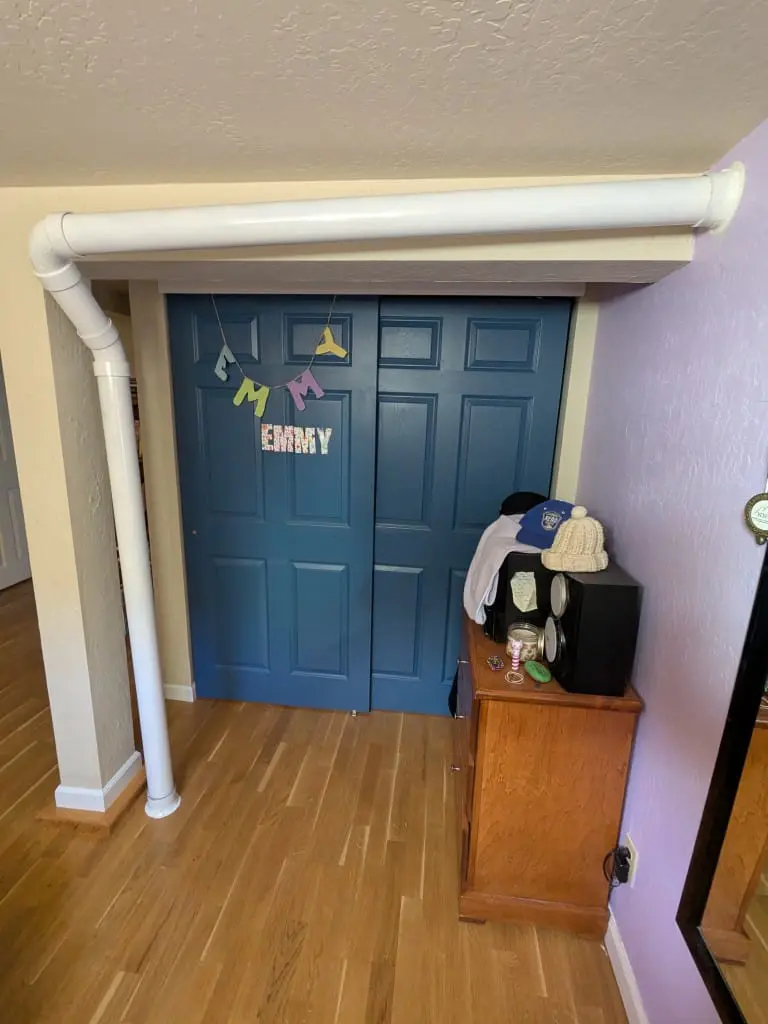 Radon mitigation looks different depending on the layout of a home. Here, white pipes bringing radon-rich air out of the house are installed in a bedroom. Photo Mike Escobar / Sierra Nevada Ally