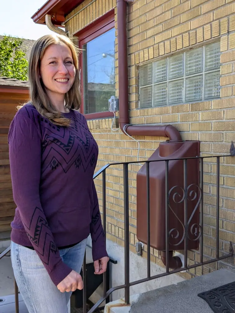 Reno resident Heather Gage poses next to a radon mitigation system installed outside her home. The red box contains a fan that pumps radon from beneath the ground and sends it out of an exhaust vent at the top of the home. Photo Mike Escobar / Sierra Nevada Ally