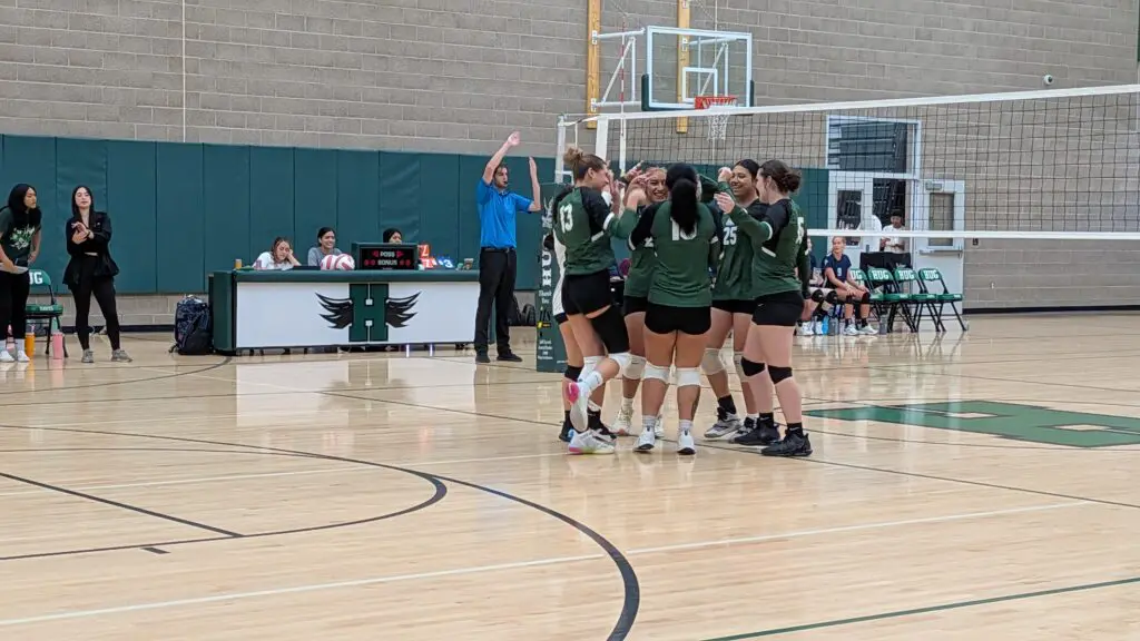 The varsity girls excitedly congratulate each other after winning another point.