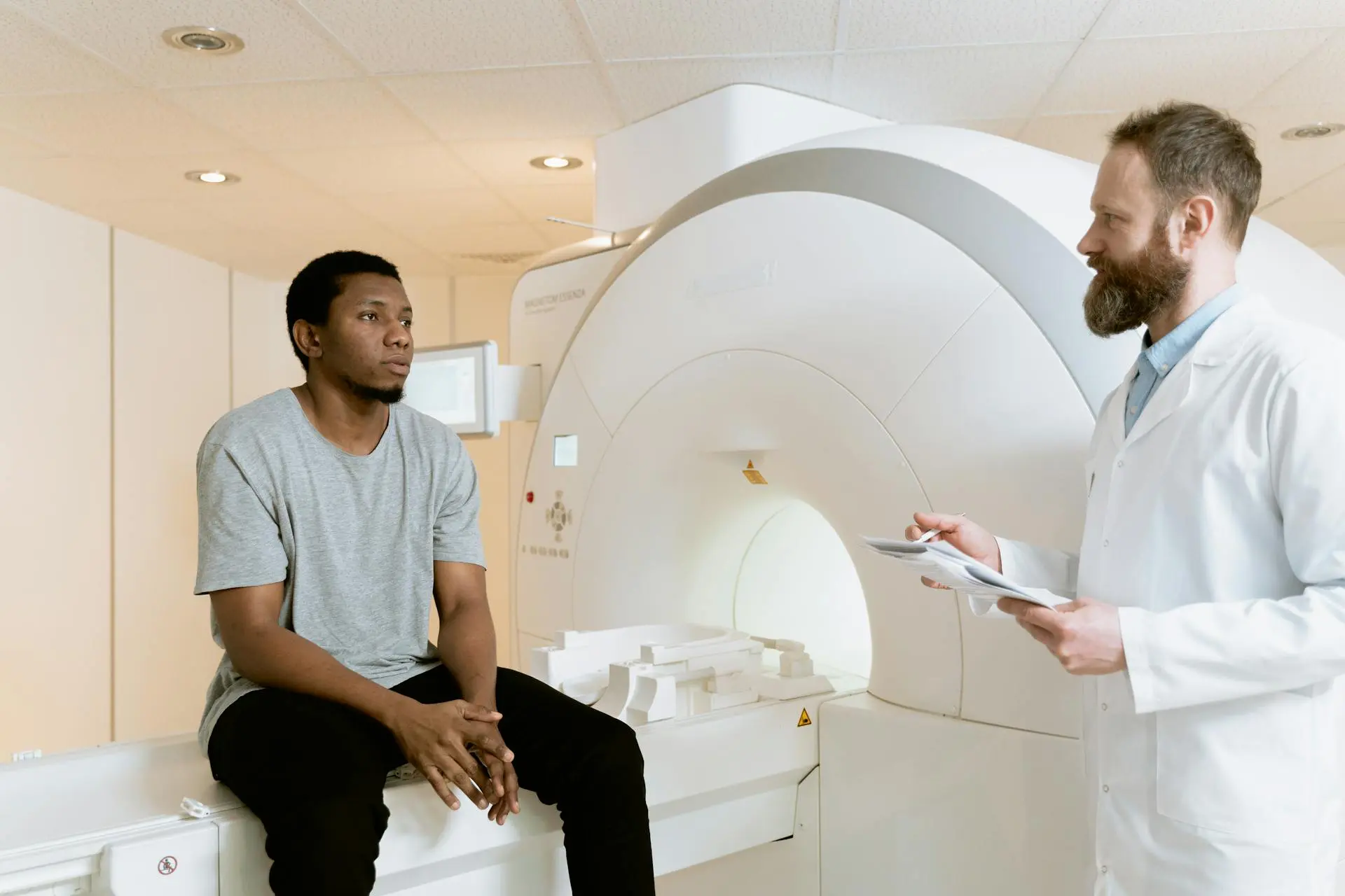 Photo Of Man Sitting On A CT Scanner