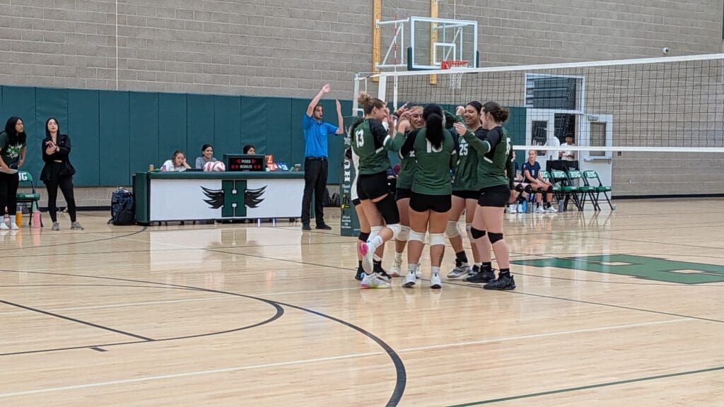 The varsity girls excitedly congratulate each other after winning another point.