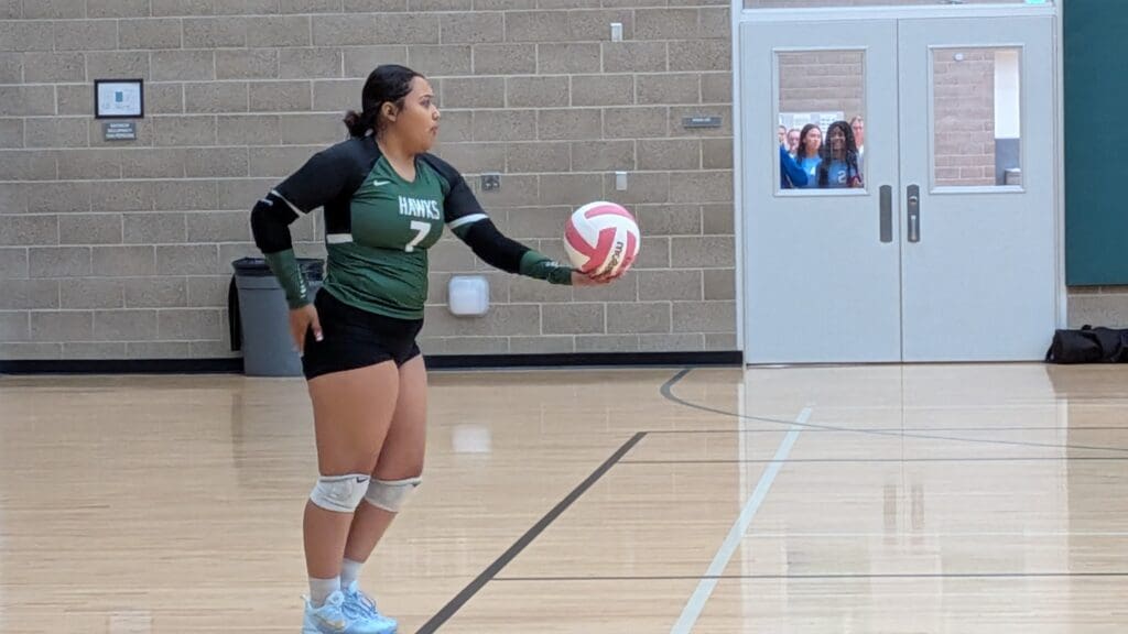 Senior Melissa Salas Lara prepares to serve the ball.