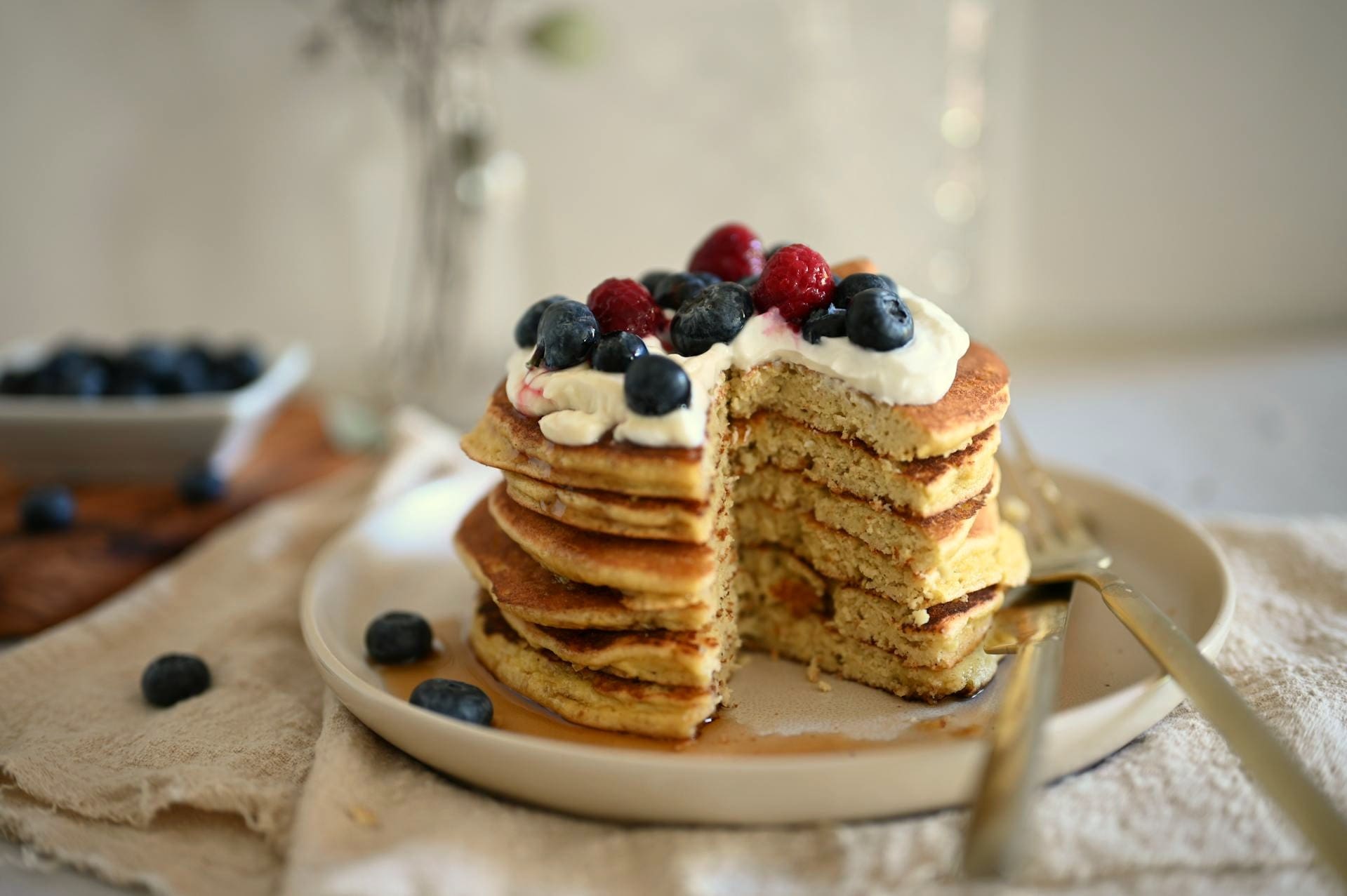 Photo by eat kubba: https://www.pexels.com/photo/pancakes-with-whipped-cream-and-berries-11842148/