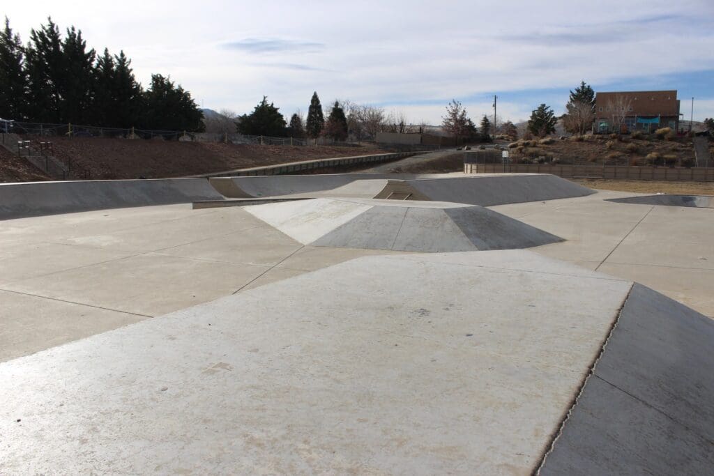 The skatepark has a bunch of different features like quarter-pipes, ramps, rails, ledges, and even a bowl that goes from mellow to deep.
