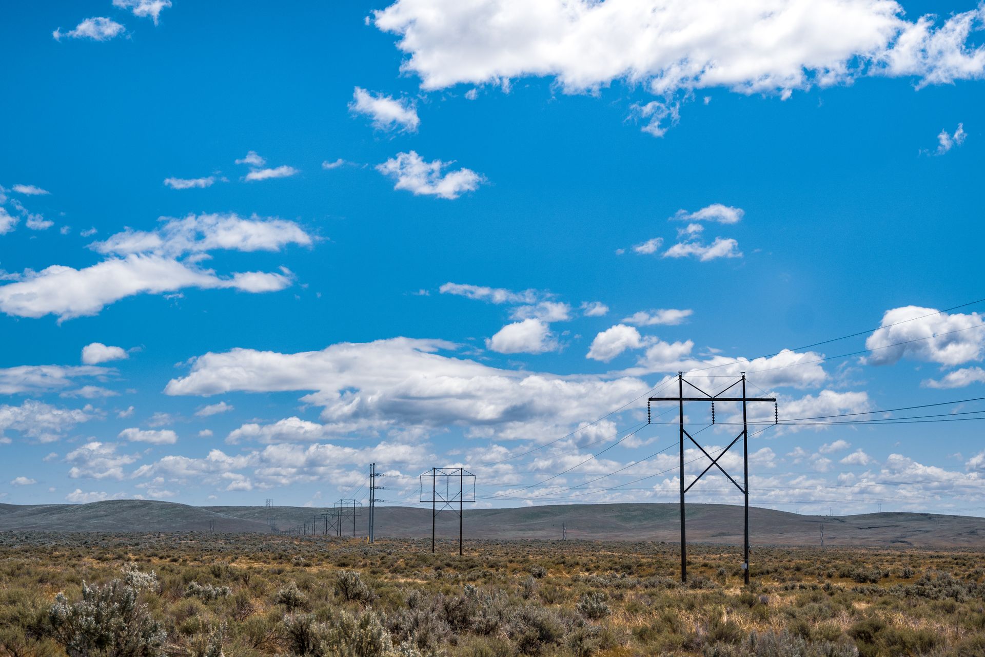 Photo by Brett Sayles from Pexels: https://www.pexels.com/photo/gray-metal-electric-posts-on-brown-grass-field-under-blue-and-white-cloudy-sky-4619535/