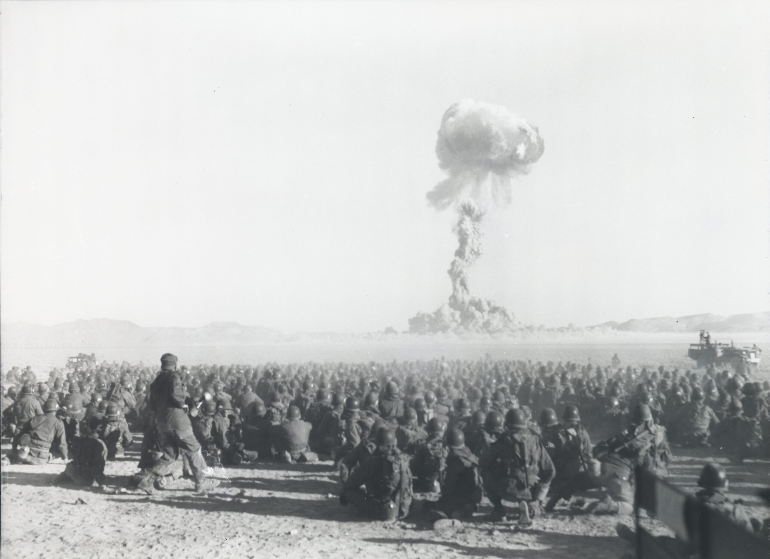 Operation Buster-Jangle: 'Dog' test, with troops participating in exercise Desert Rock I. It was the first U.S. nuclear field exercise conducted on land; troops shown are a mere 6 miles from the blast. At the Nevada Test Site, 1 November 1951. Federal Government of the United States, Public domain, via Wikimedia Commons.